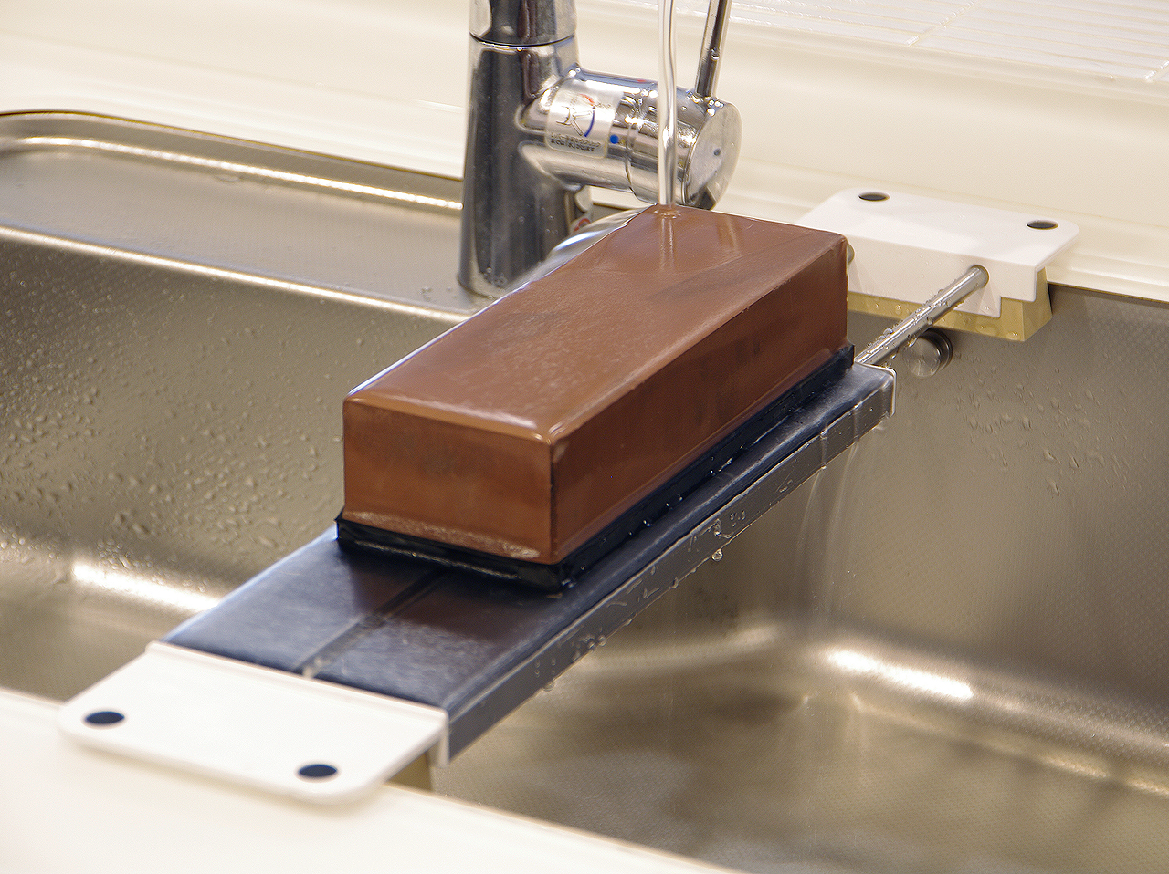 Lay across the sink and use while letting water run