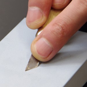 Use the reverse side of a seal-engraving blade